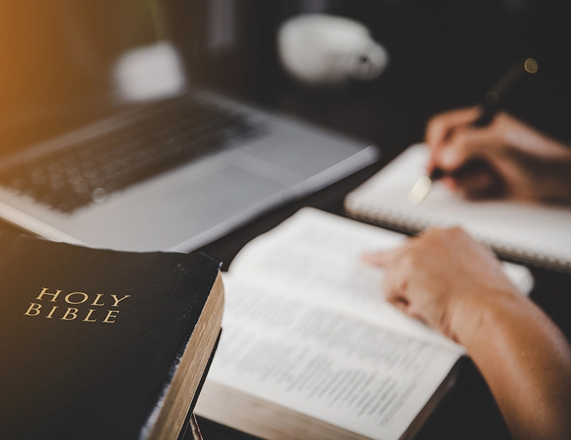 Female Bible study author writing a new lesson.